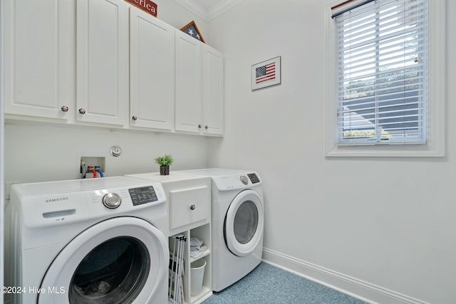 laundry room with washer and dryer, cabinets, and crown molding