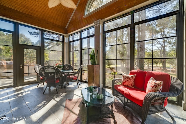 sunroom featuring plenty of natural light, ceiling fan, wood ceiling, and vaulted ceiling