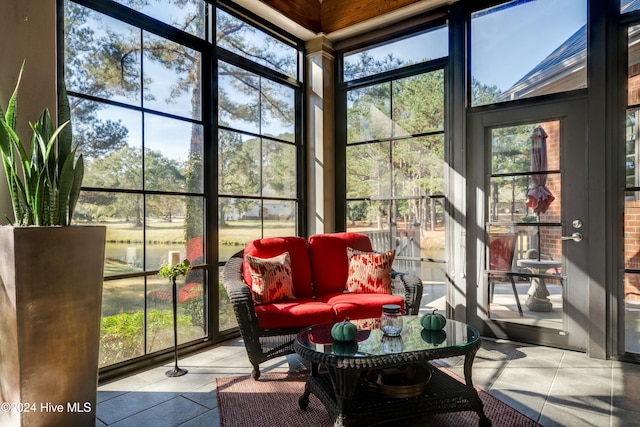 sunroom / solarium featuring a water view