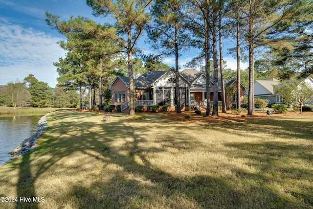 ranch-style home featuring a front lawn and a water view