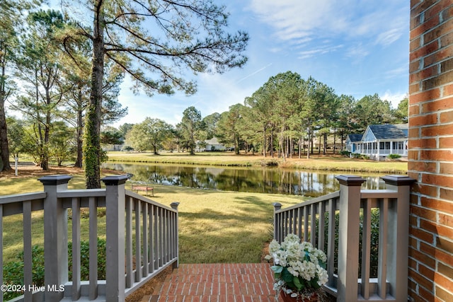 exterior space featuring a yard and a water view