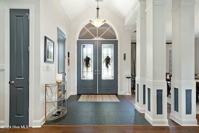 foyer entrance with dark hardwood / wood-style floors, lofted ceiling, and french doors