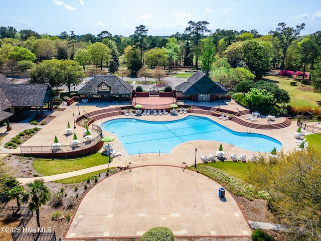 pool with fence and a patio area