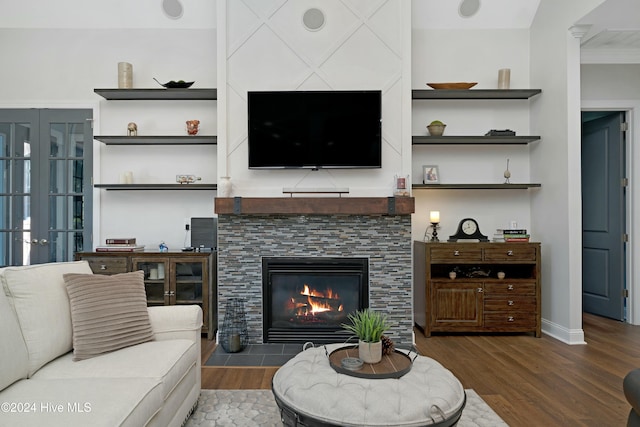 living room with a fireplace and dark hardwood / wood-style flooring