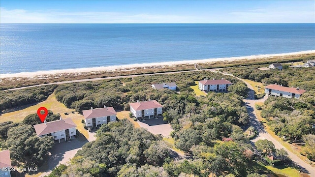 birds eye view of property with a water view and a view of the beach