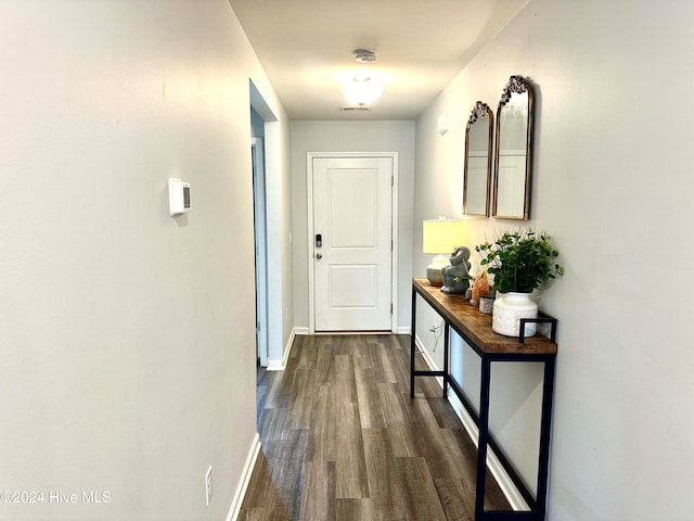 corridor with dark hardwood / wood-style flooring