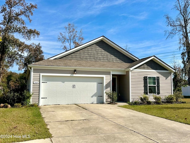 view of front of house with a front yard and a garage