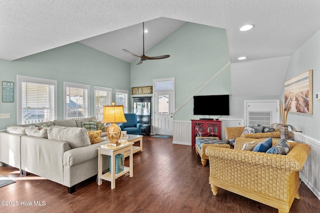 living room with dark wood-type flooring, a textured ceiling, high vaulted ceiling, and ceiling fan