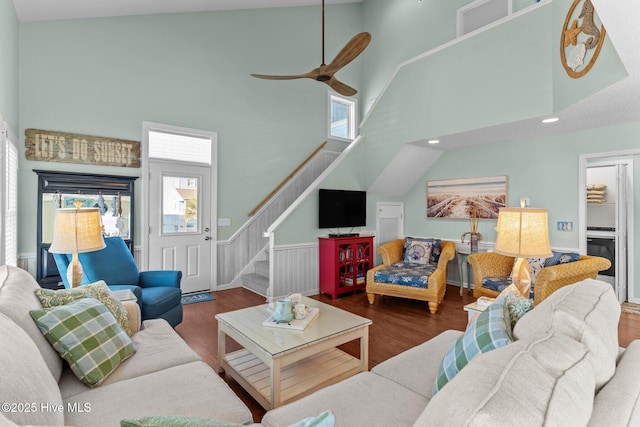 living room with hardwood / wood-style flooring, high vaulted ceiling, and ceiling fan