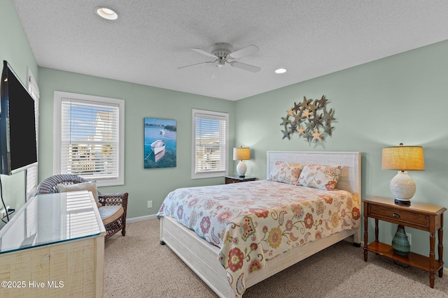 carpeted bedroom featuring a textured ceiling and ceiling fan