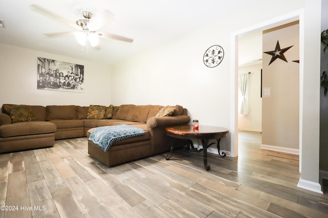 living room with light hardwood / wood-style floors and ceiling fan