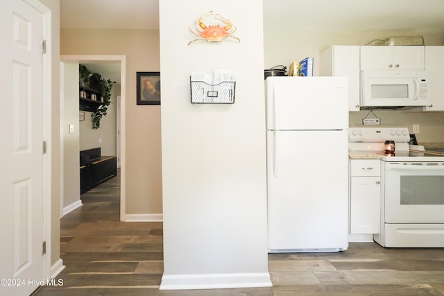 kitchen with dark hardwood / wood-style flooring, white cabinets, and white appliances