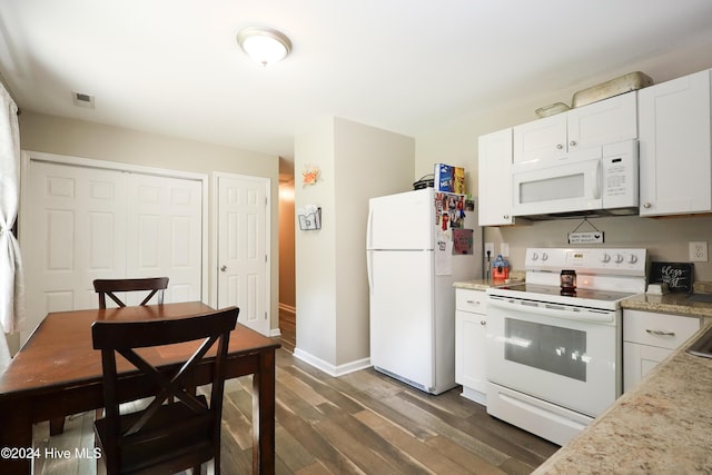 kitchen with white cabinets, dark hardwood / wood-style flooring, and white appliances