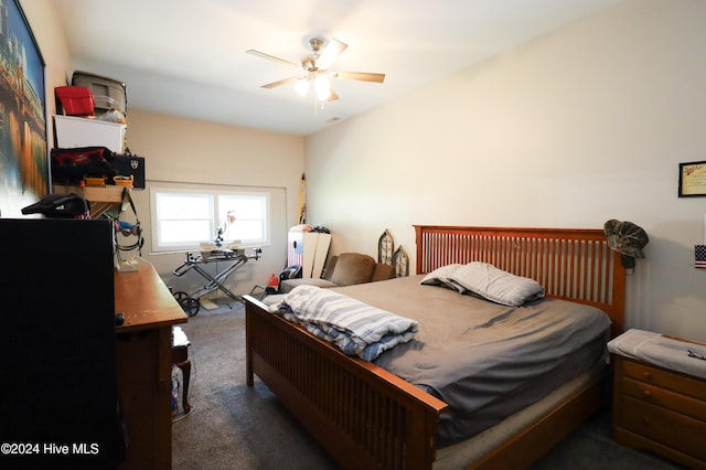 bedroom featuring dark colored carpet and ceiling fan