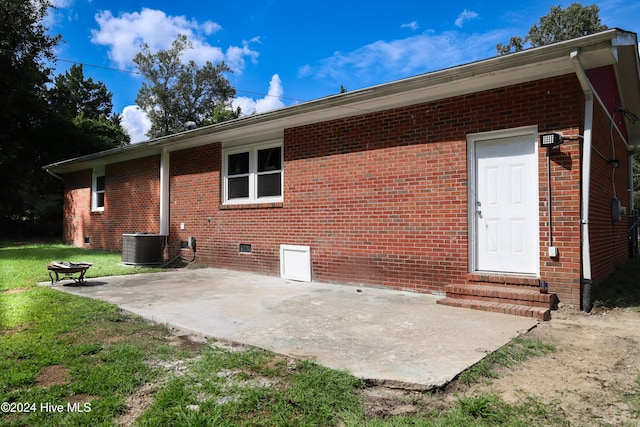 rear view of house featuring a yard, a patio, and central AC unit