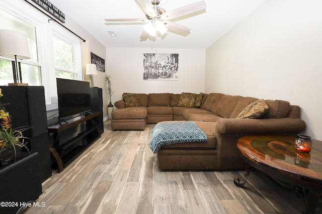 living room with ceiling fan and light hardwood / wood-style flooring