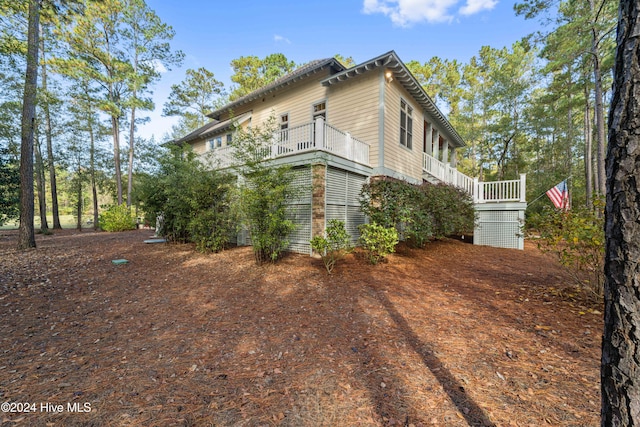 view of home's exterior with a balcony