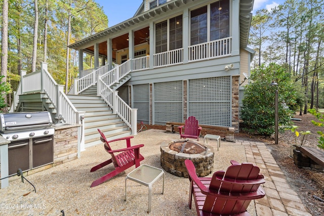 rear view of house with stairs, an outdoor fire pit, and a patio area