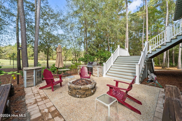 view of patio with an outdoor fire pit and stairway