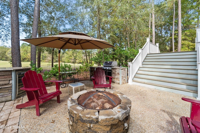 view of patio with a fire pit, wine cooler, and area for grilling