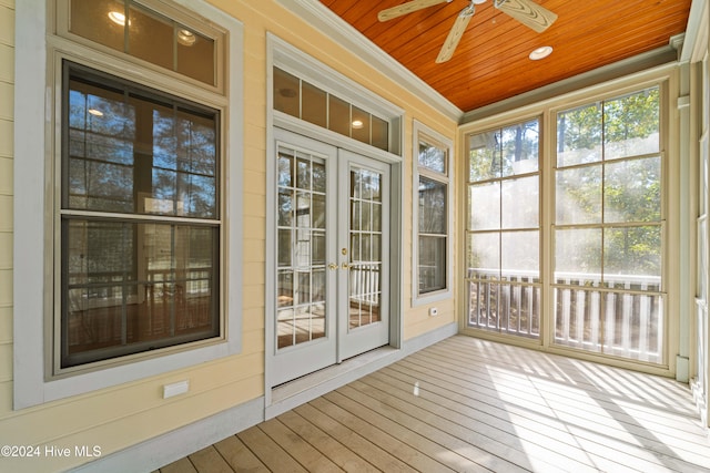 unfurnished sunroom featuring french doors, wood ceiling, and a ceiling fan