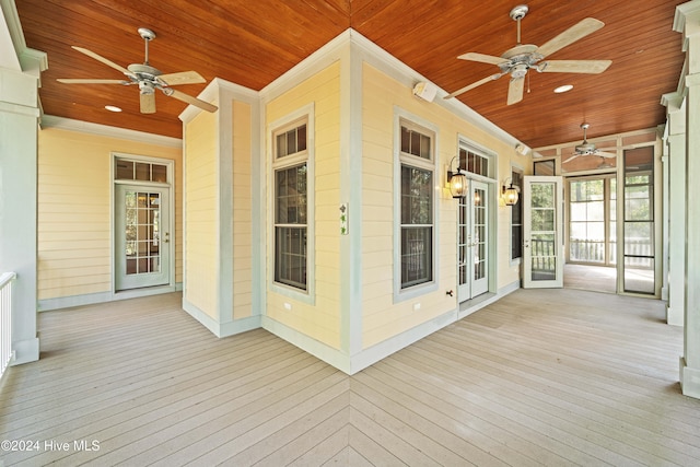 wooden terrace featuring french doors and a ceiling fan