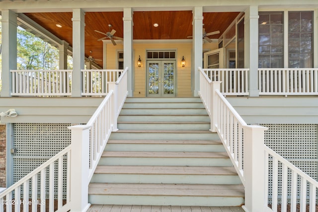 view of exterior entry featuring a porch and french doors