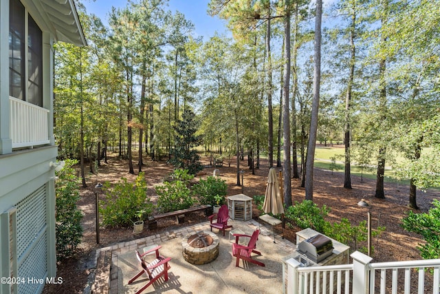 242 River Woods Dr, Wallace, NC 28466 - view of patio featuring an outdoor fire pit and view of scattered trees