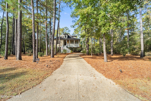 view of front of home with driveway and a porch