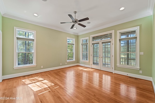 spare room with light wood-type flooring, visible vents, ornamental molding, and french doors