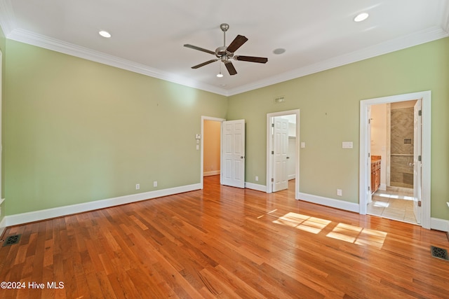 unfurnished bedroom featuring light wood-style flooring, baseboards, and crown molding