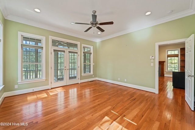 unfurnished room featuring light wood finished floors, baseboards, crown molding, french doors, and recessed lighting