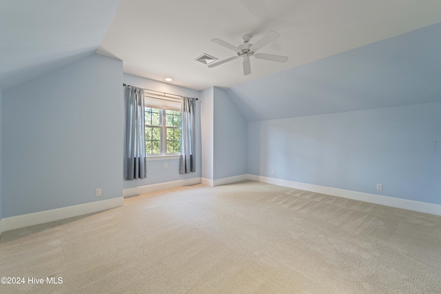 bonus room with visible vents, vaulted ceiling, light carpet, and baseboards