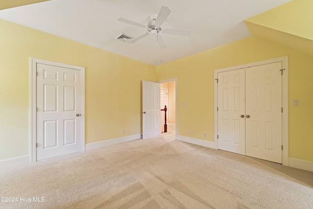 unfurnished bedroom featuring carpet floors, baseboards, visible vents, and a closet