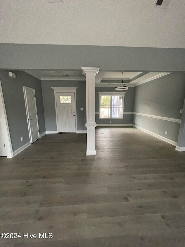 foyer featuring crown molding, dark wood-type flooring, and decorative columns