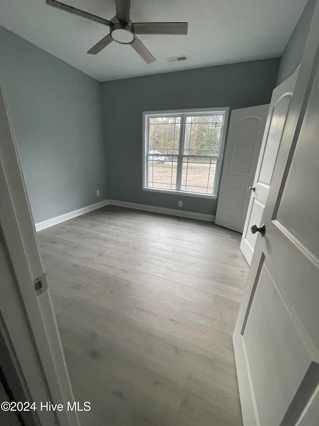 interior space with ceiling fan and light wood-type flooring