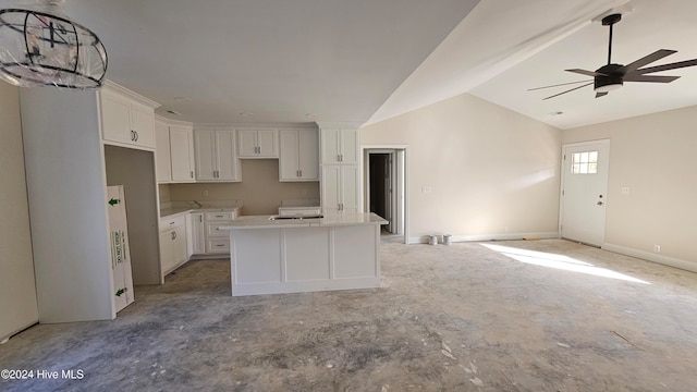 kitchen featuring lofted ceiling, ceiling fan, a center island, and white cabinets