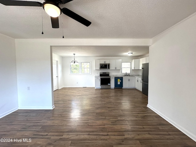 unfurnished living room featuring a textured ceiling, sink, ceiling fan with notable chandelier, and dark hardwood / wood-style floors