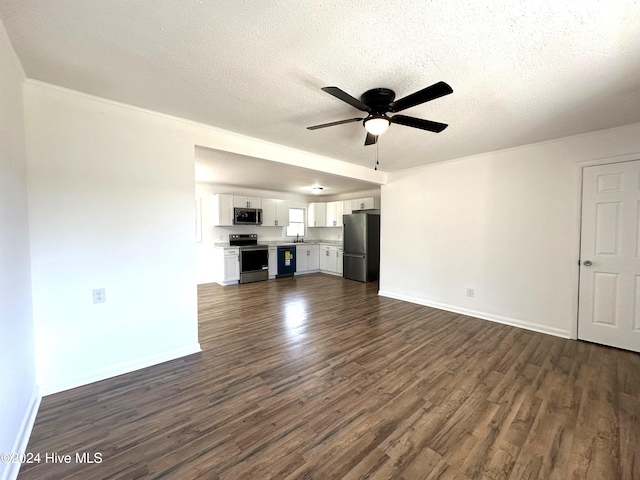 unfurnished living room featuring a textured ceiling, dark hardwood / wood-style floors, ceiling fan, and sink