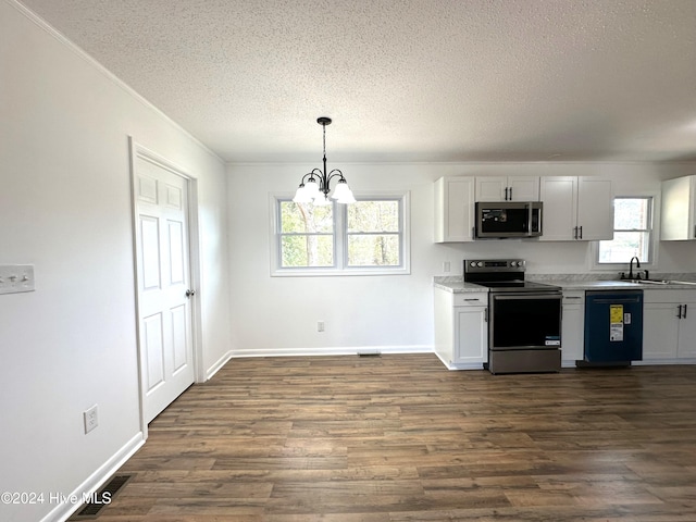 kitchen with stainless steel appliances, white cabinetry, and a wealth of natural light