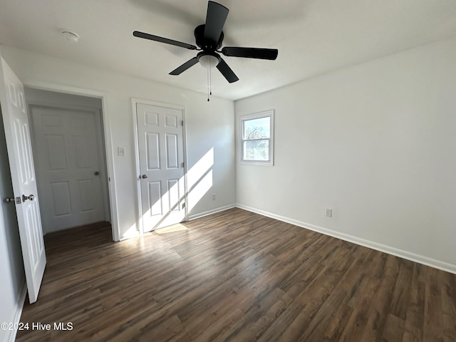 spare room featuring dark hardwood / wood-style floors and ceiling fan