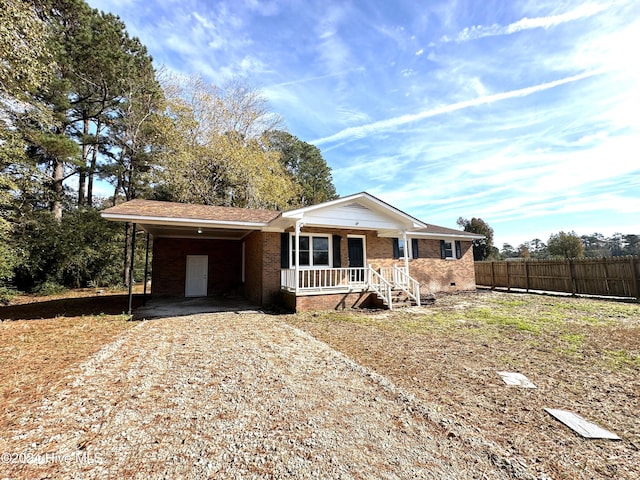 single story home with a porch and a carport