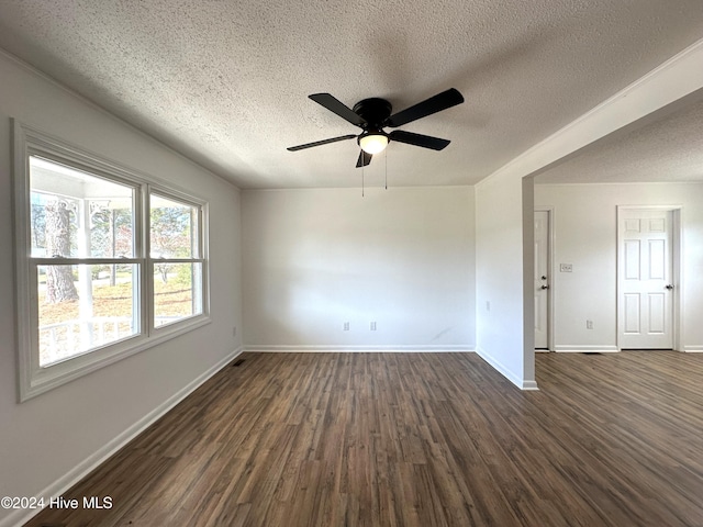 spare room with ceiling fan, dark hardwood / wood-style flooring, and a textured ceiling