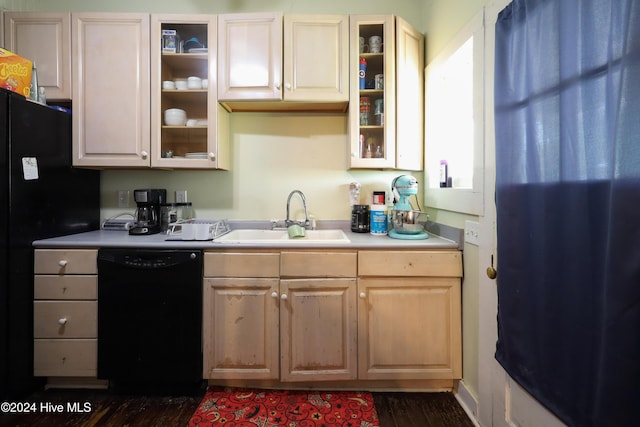 kitchen featuring light brown cabinets, sink, black dishwasher, and dark wood-type flooring