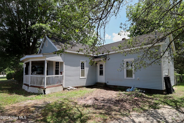 back of house featuring covered porch