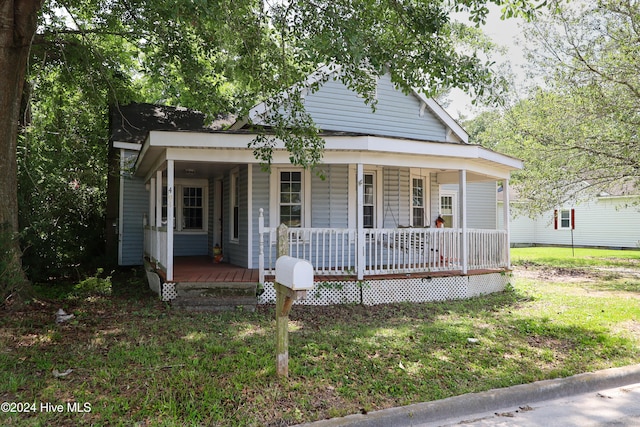 bungalow-style home featuring a porch and a front yard