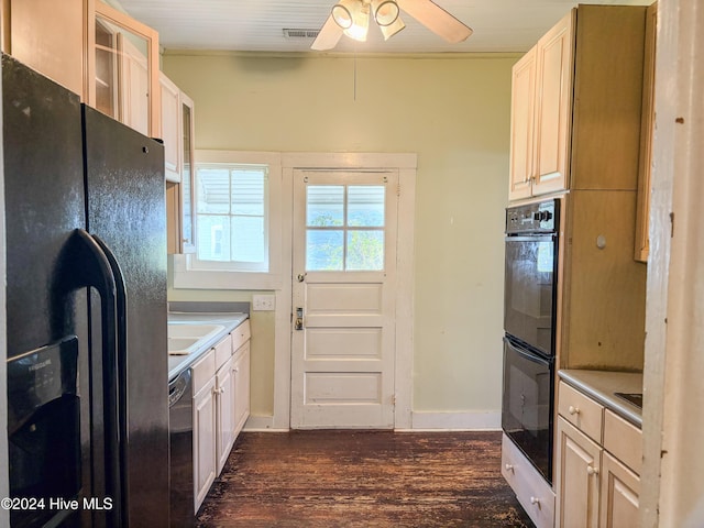 kitchen featuring black appliances, dark hardwood / wood-style floors, ceiling fan, and sink