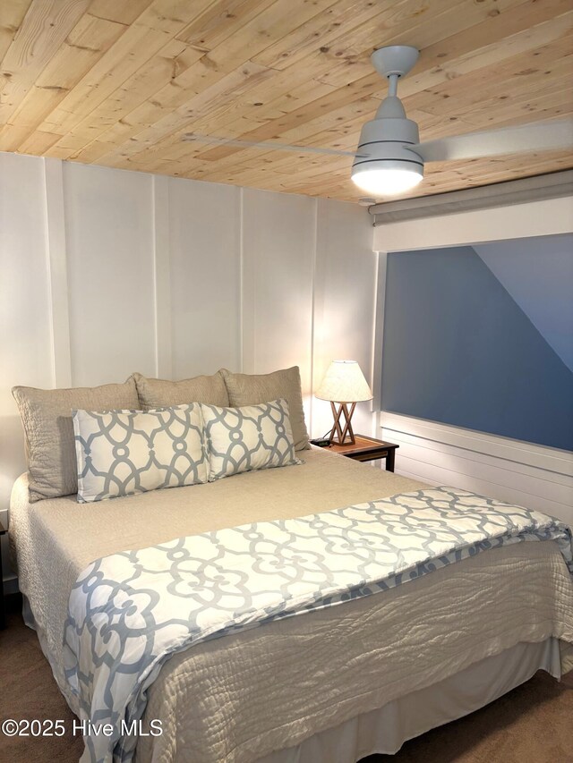 bedroom with ceiling fan, light colored carpet, and a textured ceiling