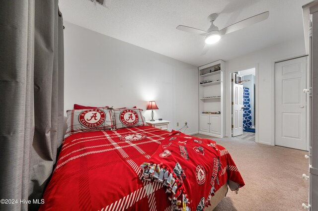 carpeted bedroom with ceiling fan and a textured ceiling