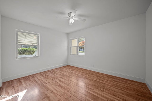 empty room with light wood-type flooring and ceiling fan